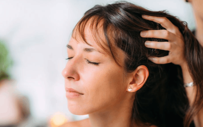 lady is getting scalp massage 