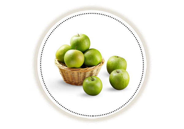 Green apples in a wicker basket on a white background