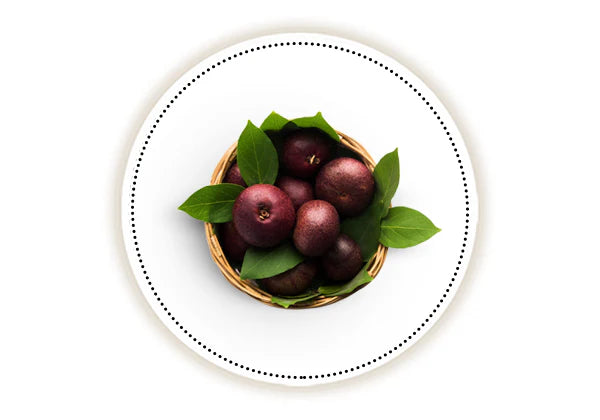 Basket of kokum berries with leaves on a white background